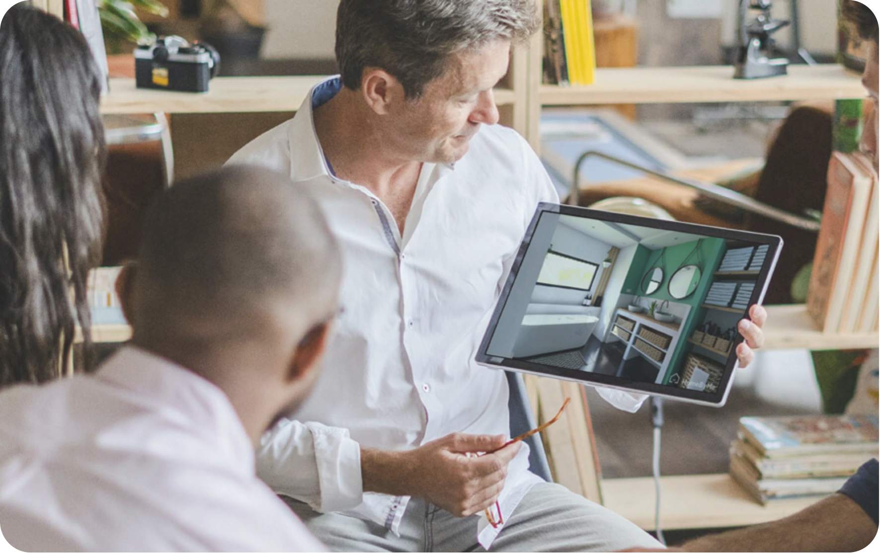 A food brand founder looking at a live ERP dashboard on a laptop, showing key F&B metrics like shelf life, cold chain status, and inventory levels.