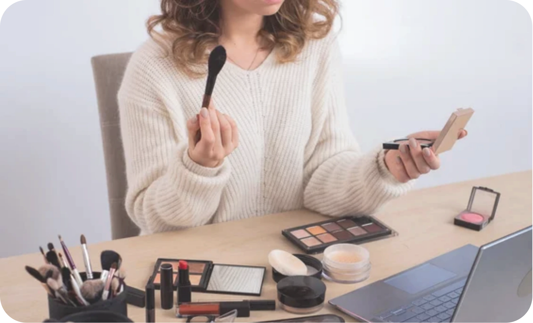 A food brand founder looking at a live ERP dashboard on a laptop, showing key F&B metrics like shelf life, cold chain status, and inventory levels.